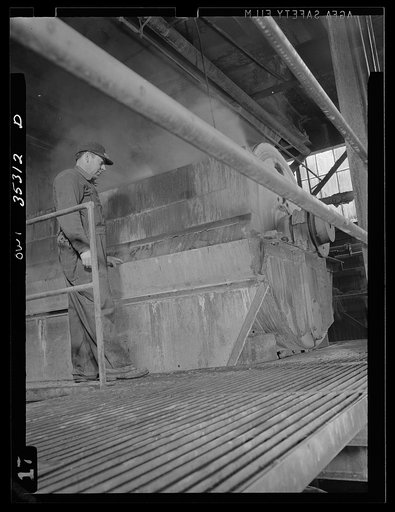 San Francisco, California. Processing tin which has been removed from salvaged cans at the metal and thermite company