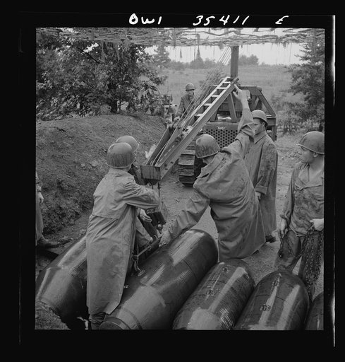 Greenville, South Carolina. Air Service Command. Men of the ordnance, supply and maintenance company of the 25th service group taking 2000 pound bombs out of the revetment area