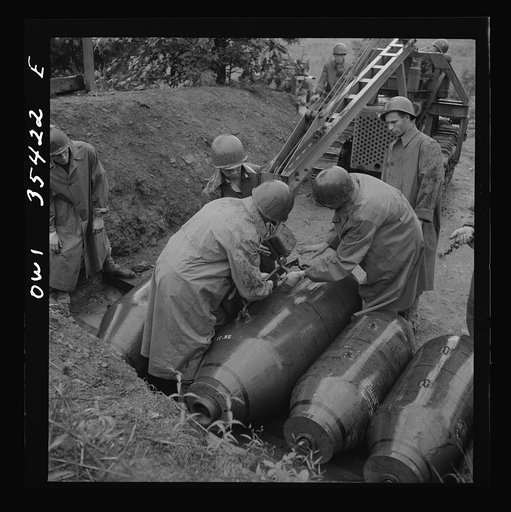 Greenville, South Carolina. Air Service Command. Men of the ordnance, supply and maintenance company of the 25th service group taking 2000 pound bombs out of the revetment area