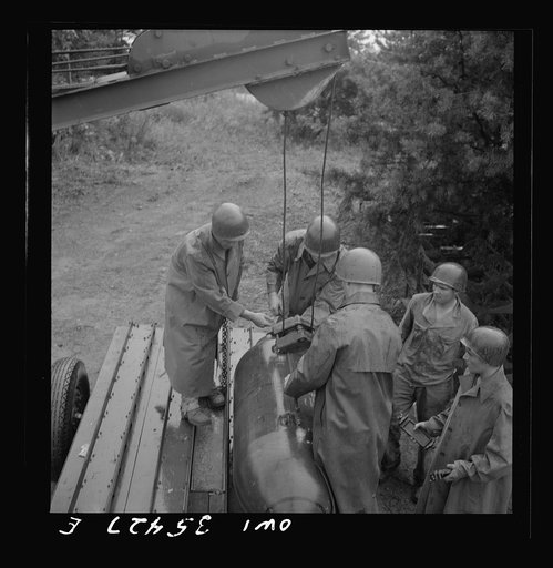 Greenville, South Carolina. Air Service Command. Men of the ordnance, supply and maintenance company of the 25th service group taking 2000 pound bombs out of the revetment area