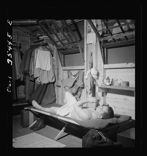 Greenville, South Carolina. Air Service Command. A scene in one of the barracks. Enlisted man playing a flute after he has taken a shower