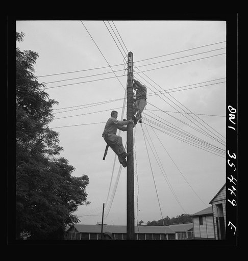 Untitled photo, possibly related to: Greenville, South Carolina. Air Service Command. Men of the 1067th signal company of the 25th service group stringing telephone wire