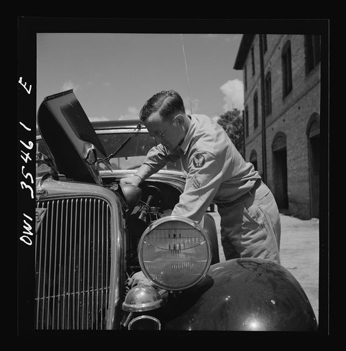 Bowman, South Carolina. Sergeant John Riley of the 25th service group, Air Service Command, on leave at his home. He is tuning up his old Ford, preparing to go see his girlfriend