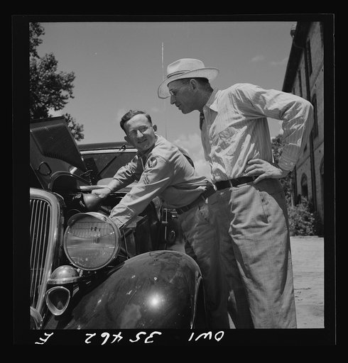 Untitled photo, possibly related to: Bowman, South Carolina. Sergeant John Riley of the 25th service group, Air Service Command, on leave at his home. He is tuning up his old Ford, preparing to go see his girlfriend