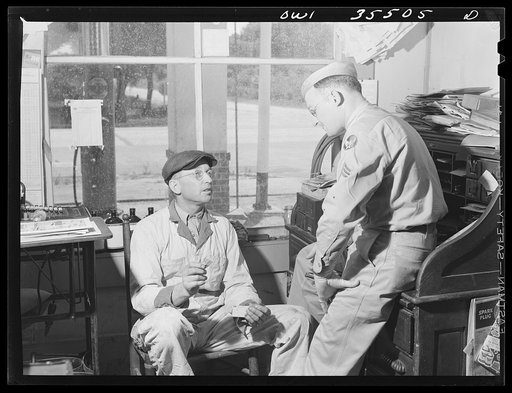 Bowman, South Carolina. Sergeant John Riley, of the 25th service group, Air Service Command, home on leave, listening to his father explaining gas rationing. Before enlisting in the Army, he worked in his father's garage for many years