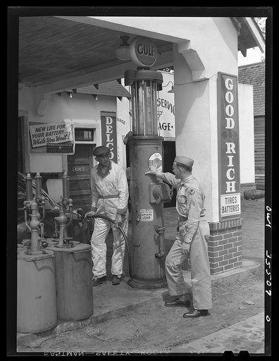 Bowman, South Carolina. Sergeant John Riley, of the 25th service group, Air Service Command, home on leave, being shown around the garage where he used to work by his father