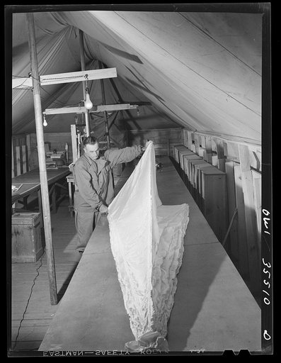 Greenville, South Carolina. Air Service Command. Inspecting parachutes at the 35th service squadron of the 25th service group