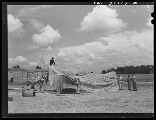 Greenville, South Carolina. Air Service Command. Men of the 35th service squadron of the 25th service group, spreading camouflage netting over a plane