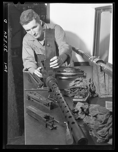 Greenville, South Carolina. Air Service Command. Enlisted man of the 1756th ordnance, supply and maintenance company overhauling a fifty-calibre machine gun
