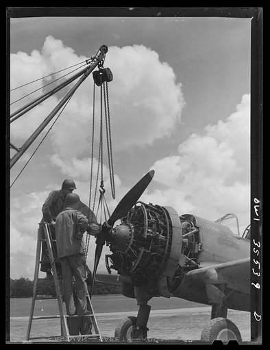 Greenville, South Carolina. Air Service Command. Men of the 35th service squadron of the 25th service group removing the propeller of a plane