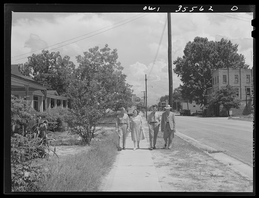 Bowman, South Carolina. Sergeant John Riley of the 25th service group, Air Service Command, on leave at home, coming out of church with his parents and brother