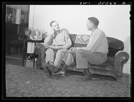 Bowman, South Carolina. Sergeant John Riley of the 25th service group, Air Service Command, at home on leave talking things over with his father