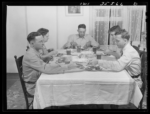 Untitled photo, possibly related to: Bowman, South Carolina. Sergeant John Riley, of the 25th service group, Air Service Command, home on leave having dinner with his family and a friend
