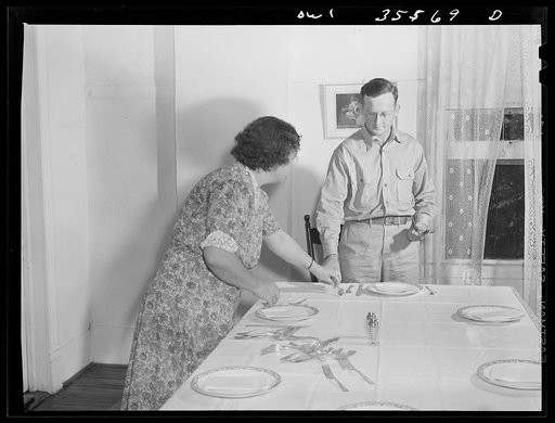 Untitled photo, possibly related to: Bowman, South Carolina. Sergeant John Riley, of the 25th service group, Air Service Command, home on leave having dinner with his family and a friend
