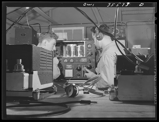Greenville, South Carolina. Air Service Command. Men of the 1067th signal company of the 25th service group, checking the calibration of an airborn radio transmitter. Left is Private Lester Mehlmen, of 1319 Carmen Street, Chicago, Illinois, and right, Private Charles Nasopust, 2222 South Hainsworth 