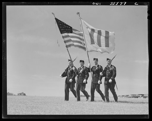 The United Nations flag, an unofficial design by Brooks B. Harding, with four bars symbolizing the Four Freedoms beside the Stars and Stripes