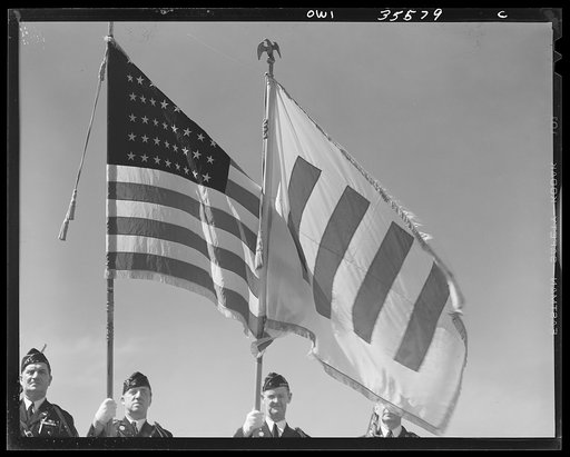 The United Nations flag, an unofficial design by Brooks B. Harding, with four bars symbolizing the Four Freedoms beside the Stars and Stripes