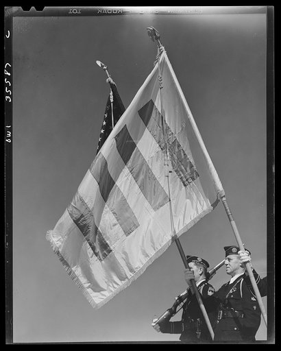 The United Nations flag, an unofficial design by Brooks B. Harding with four bars symbolizing the Four Freedoms beside the Stars and Stripes