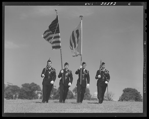 The United Nations flag, an unofficial design by Brooks B. Harding, with four bars symbolizing the Four Freedoms beside the Stars and Stripes
