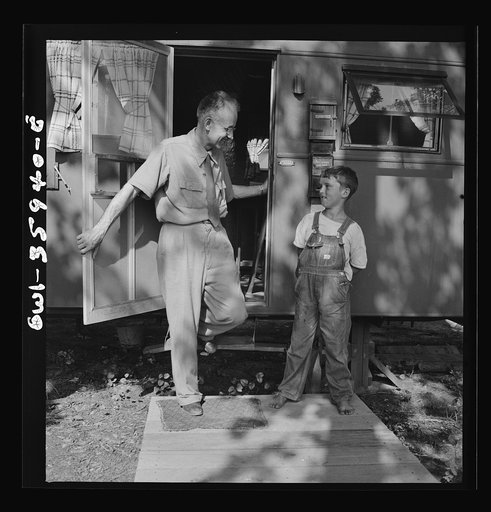 Middle River, a small crossroads in the vicinity of Baltimore, Maryland. FSA (Farm Security Administration) housing project (later administered by the National Housing Agency) for Glenn L. Martin aircraft workers. Francis R. Casselman, the chaplain, with the small son of a resident