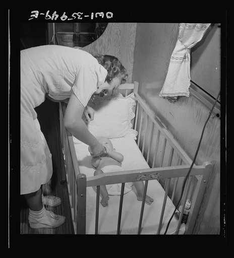 Middle River, Maryland. A FSA (Farm Security Administration) housing project (later administered by the National Housing Agency) for Glenn L. Martin aircraft workers. Mother feeding a baby
