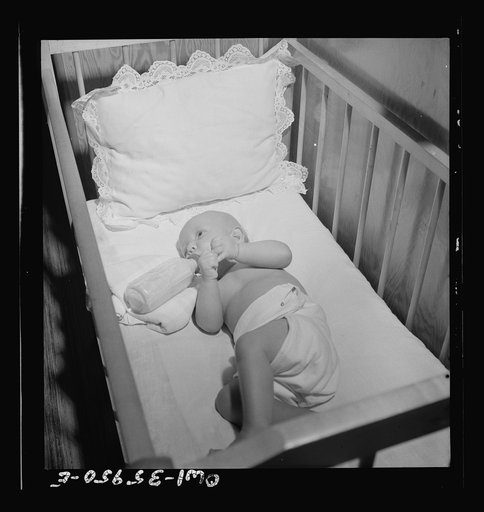 Middle River, Maryland. A FSA (Farm Security Administration) housing project (later administered by the National Housing Agency) for Glenn L. Martin aircraft workers. A baby drinking from its bottle