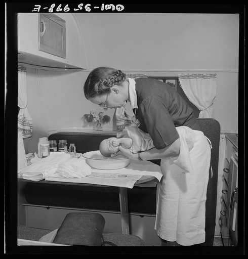 Middle River, a small crossroads in the vicinity of Baltimore, Maryland. FSA (Farm Security Administration) housing project (later administered by the National Housing Agency) for Glenn L. Martin aircraft workers. Mrs. Phyllis Phair, a public health nurse, demonstrating to a young mother how to bath