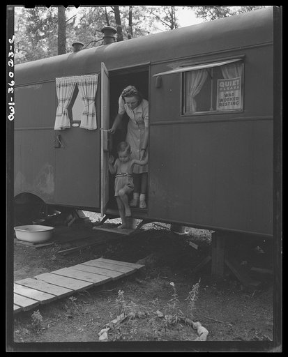 Middle River, Maryland. FSA (Farm Security Administration) housing project for Glenn L. Martin aircraft workers. Mrs. George Davis and her son in the doorway of their trailer home