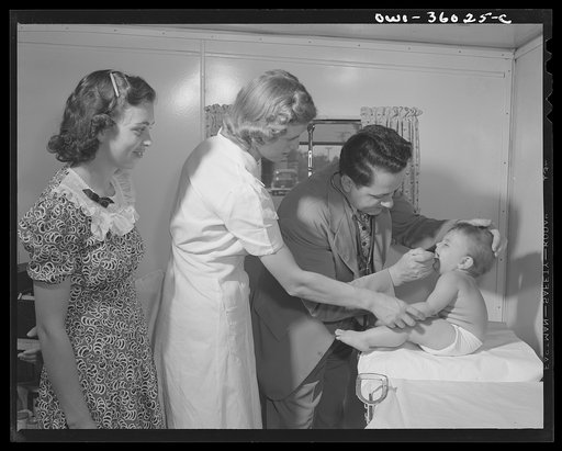 Middle River, a small crossroads in the vicinity of Baltimore, Maryland. FSA (Farm Security Administration) housing project (later administered by the National Housing Agency) for Glenn L. Martin aircraft workers. Mrs. Cecil C. Irp having her child examined by Dr. P.R. Estep, trailer camp doctor who