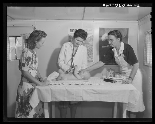 Middle River, a small crossroads in the vicinity of Baltimore, Maryland. FSA (Farm Security Administration) housing project (later administered by National Housing Agency) for Glenn L. Martin aircraft workers. Mrs. George Davis having her child examined at the Public Health well baby clinic conducte