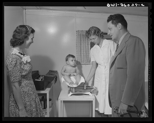 Middle River, a small crossroads in the vicinity of Baltimore, Maryland. FSA (Farm Security Administration) housing project (later administered by the National Housing Agency) for Glenn L. Martin aircraft workers. Mrs. Cecil C. Irp having her child examined by Dr. P.R. Estep, trailer camp doctor, wh
