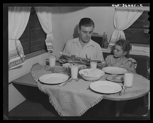 Untitled photo, possibly related to: Middle River, Maryland. FSA (Farm Security Administration) housing project for Glenn L. Martin aircraft workers. Mrs. Emma D. Gaw, assistant project service advisor, serving dinner in her trailer home to her husband who works in the plant and to her daughter