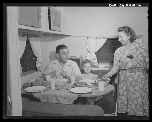 Untitled photo, possibly related to: Middle River, Maryland. FSA (Farm Security Administration) housing project for Glenn L. Martin aircraft workers. Mrs. Emma D. Gaw, assistant project service advisor, serving dinner in her trailer home to her husband who works in the plant and to her daughter