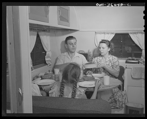 Middle River, Maryland. FSA (Farm Security Administration) housing project for Glenn L. Martin aircraft workers. Mrs. Emma D. Gaw, assistant project service advisor, serving dinner in her trailer home to her husband, who works in the Glenn Martin plant, and to her six year old daughter