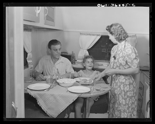 Untitled photo, possibly related to: Middle River, Maryland. FSA (Farm Security Administration) housing project for Glenn L. Martin aircraft workers. Mrs. Emma D. Gaw, assistant project service advisor, serving dinner in her trailer home to her husband who works in the plant and to her daughter