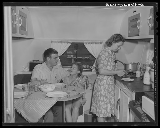 Middle River, Maryland. FSA (Farm Security Administration) housing project for Glenn L. Martin aircraft workers. Mrs. Emma D. Gaw, assistant project service advisor, serving dinner in her trailer home to her husband who works in the plant and to her daughter