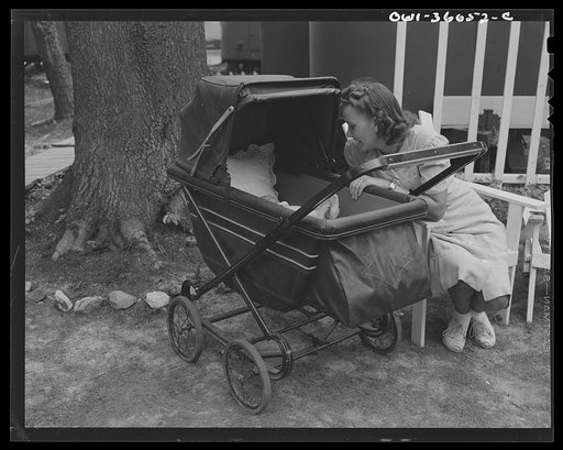 Middle River, Maryland. FSA (Farm Security Administration) housing project (later administered by the National Housing Agency) for Glenn L. Martin aircraft workers. Mrs. George Davis with her baby outside her trailer home