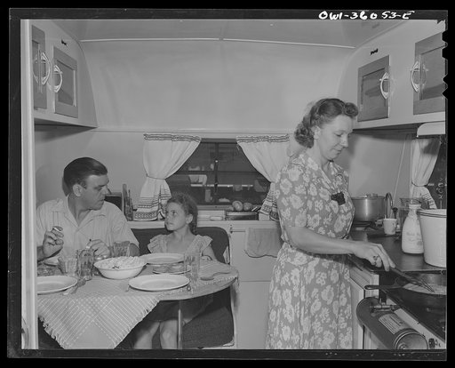 Middle River, Maryland. FSA (Farm Security Administration) housing project for Glenn L. Martin aircraft workers. Mrs. Emma D. Gaw, assistant project service advisor, serving dinner in her trailer home to her husband who works in the Glenn Martin plant and her six year old daughter