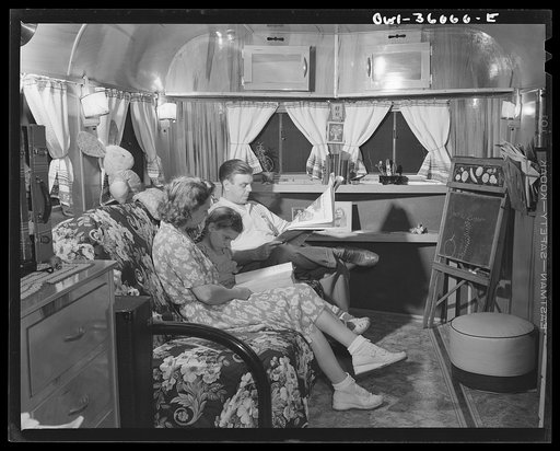 Middle River, a small crossroads in the vicinity of Baltimore, Maryland. FSA (Farm Security Administration) housing project for Glenn L. Martin aircraft workers. Mrs. Emma D. Gaw, assistant project service advisor, with her daughter and husband who works in the plant, relaxing in their trailer home