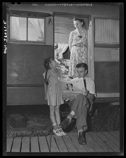 Untitled photo, possibly related to: Middle River, Maryland. FSA (Farm Security Administration) housing project for Glenn L. Martin aircraft workers. Mrs. Emma D. Gaw with her six year old daughter and husband who works at the Glenn Martin plant, enjoying the cool of the evening in the doorway of tr