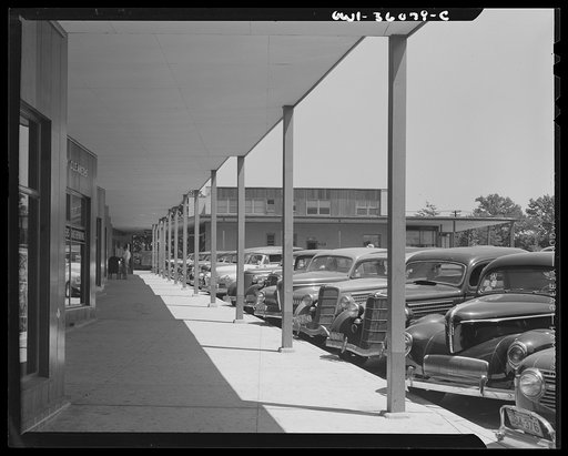 Middle River, a small crossroads in the vicinity of Baltimore, Maryland. FSA (Farm Security Administration) housing project (later administered by the National Housing Agency) for Glenn L. Martin Aircraft Plant workers. Cars parked in the shopping center