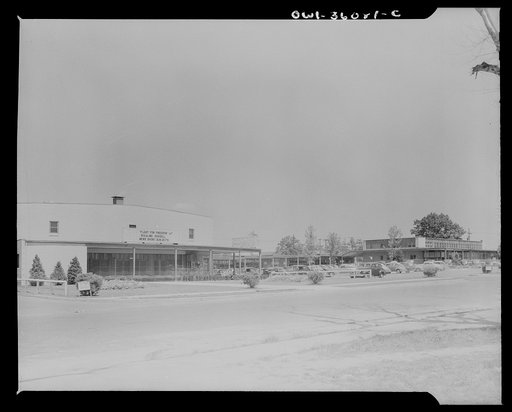 Untitled photo, possibly related to: Middle River, Maryland. A small crossroads in the vicinity of Baltimore, Maryland. FSA (Farm Security Administration) housing project (later, National Housing Agency) for Glenn L. Martin aircraft plant workers. The movie theater with cars parked in parking lot