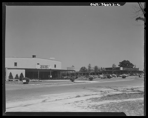Middle River, Maryland. A small crossroads in the vicinity of Baltimore, Maryland. FSA (Farm Security Administration) housing project (later, National Housing Agency) for Glenn L. Martin aircraft plant workers. The movie theater with cars parked in parking lot