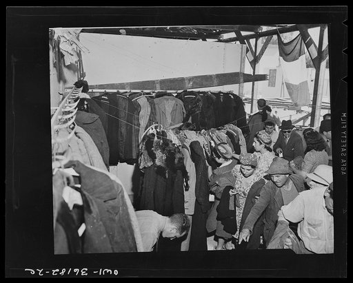 Mejex-El-Bab, Tunisia. A market operated by the Allied civilian relief groups to sell at cost food, clothing, kerosene, etc., supplied by the U.S. Office of Foreign Relief and Rehabilitation Operations to natives and Europeans, victims of war deprivation