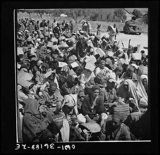 Mejex-El-Bab, Tunisia. A market operated by the Allied civilian relief groups to sell at cost food, clothing, kerosene, etc., supplied by the U.S. Office of Foreign Relief and Rehabilitation Operations to natives and Europeans, victims of war deprivation