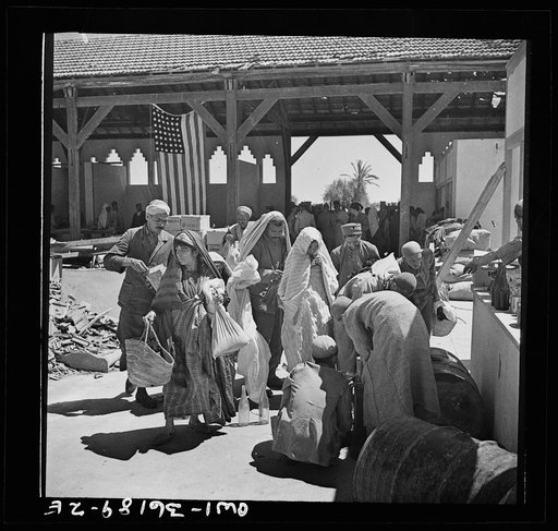 Mejex-El-Bab, Tunisia. A market operated by the Allied civilian relief groups to sell at cost food, clothing, kerosene, etc., supplied by the U.S. Office of Foreign Relief and Rehabilitation Operations to natives and Europeans, victims of war deprivation