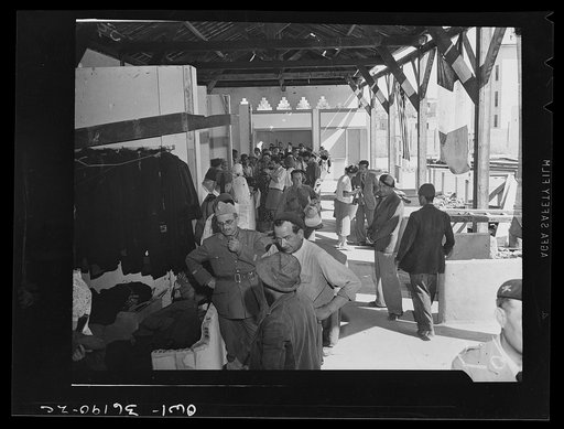 Mejex-El-Bab, Tunisia. A market operated by the Allied civilian relief groups to sell at cost food, clothing, kerosene, etc., supplied by the U.S. Office of Foreign Relief and Rehabilitation Operations to natives and Europeans, victims of war deprivation