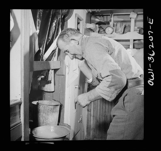 On board a fishing vessel out from Gloucester, Massachusetts. Fisherman cleaning up before dinner