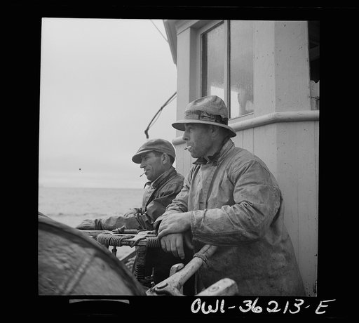 On board a fishing vessel out from Gloucester, Massachusetts. Winch control men intent on seeing to it that the proper amount of cable is let out at the proper spot