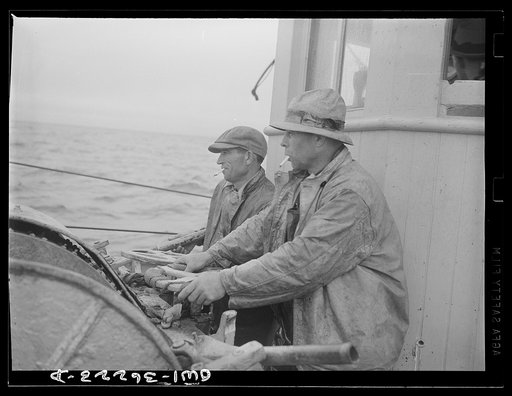 On board a fishing vessel out from Gloucester, Massachusetts. Winch control men intent on seeing to it that the proper amount of cable is let out at the proper spot